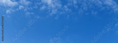 Blue sky with a few clouds background.