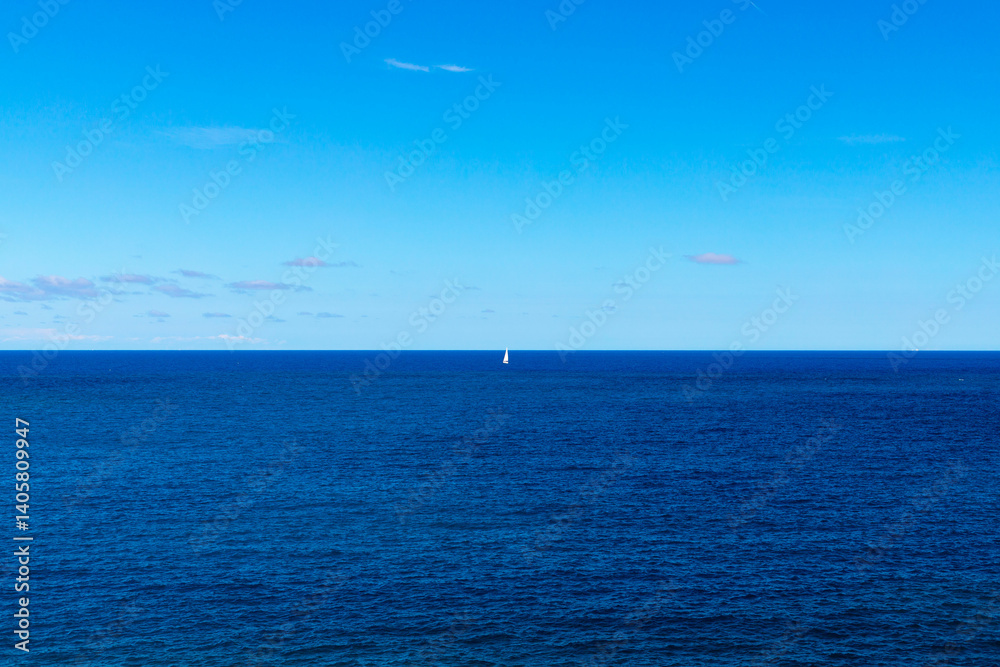 Beautiful seascape of the Adriatic Sea with a sailboat barely visible in the distance