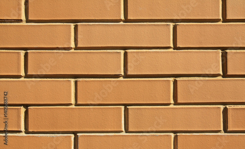 Beige brick wall, texture, background. The wall of a building, made of sand-colored bricks. Brick surface, backdrop. Yellow bricks in decorative construction. Even brickwork in exterior or interior
