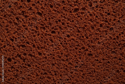 Close-up of chocolate cake texture with rich brown color and airy crumb