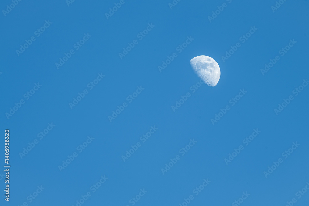 A photo of daytime Moon on a blue sky in a waxing phase (waxing gibbous) taken in Northern Hemisphere. A photo of daytime Moon on a blue sky in a waxing phase (waxing gibbous) taken in Northern Hemisphere.