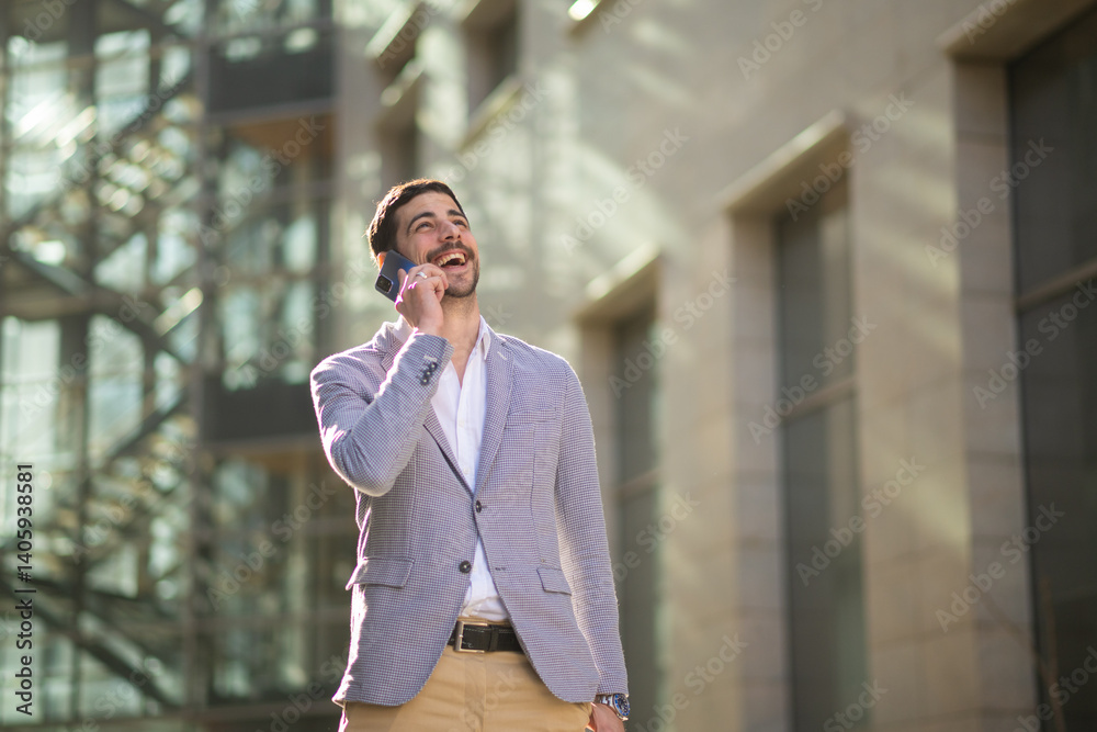 Happy businessman talking on the phone outside a modern office building. Confident male professional having a pleasant conversation in a business environment. Happy businessman talking on the phone outside a modern office building. Confident male professional having a pleasant conversation in a business environment.