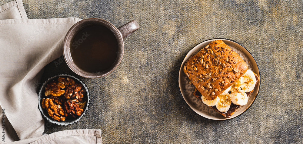 Toast rye bread with chocolate and banana on a plate on the table top view web banner