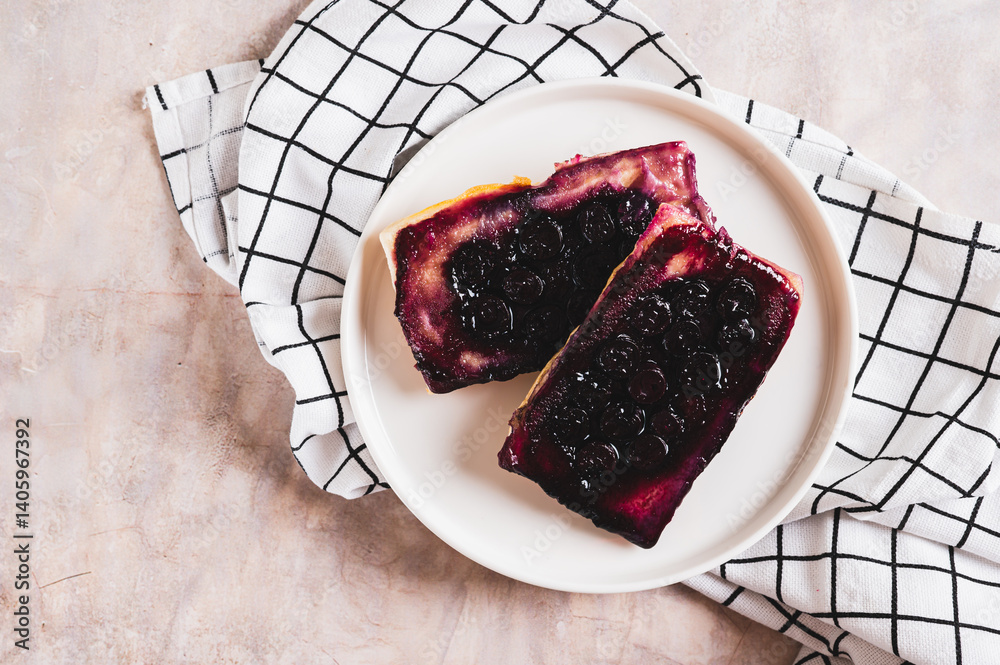 Close up of blueberry upside down pies on a plate on a table top view