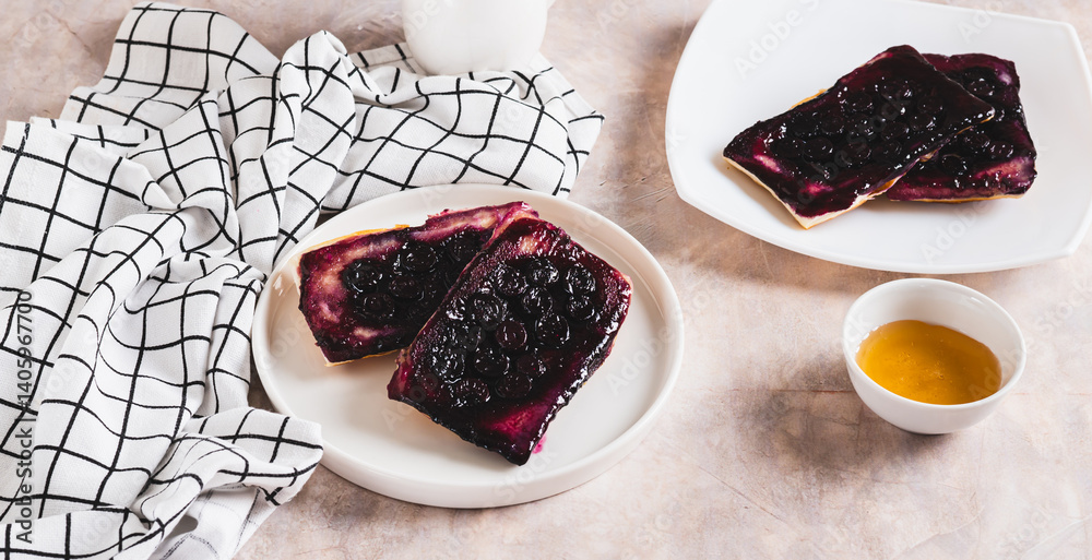 Blueberry upside down pies on a plate on a table web banner