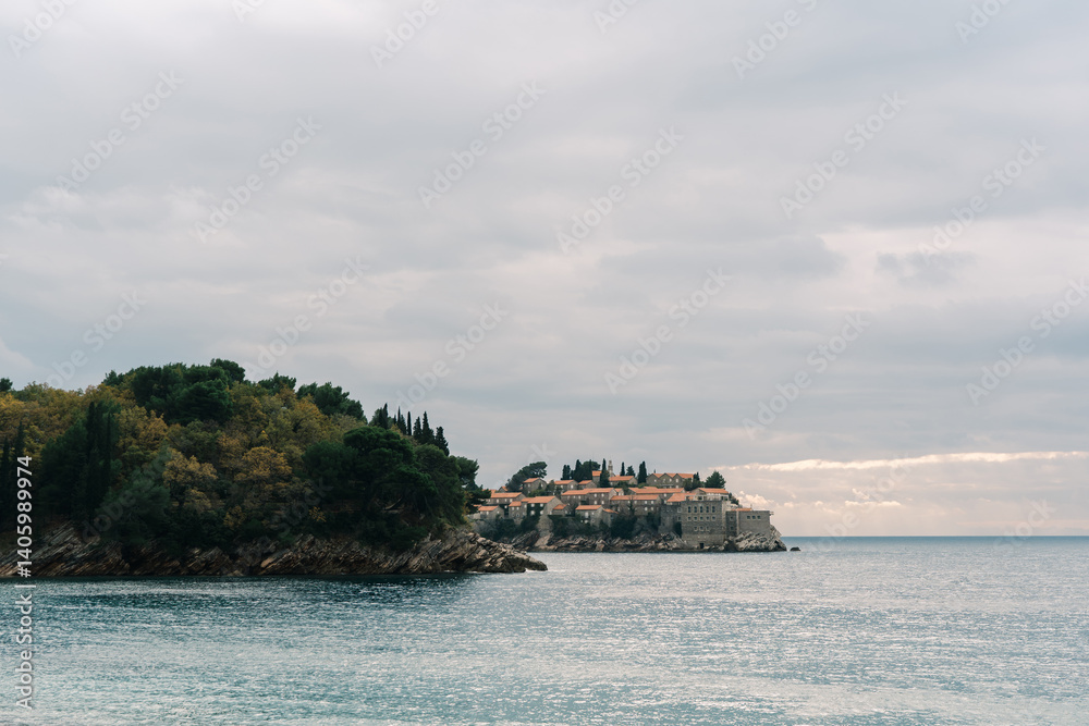 View from the sea and rocky shore to the island of Sveti Stefan. Montenegro View from the sea and rocky shore to the island of Sveti Stefan. Montenegro