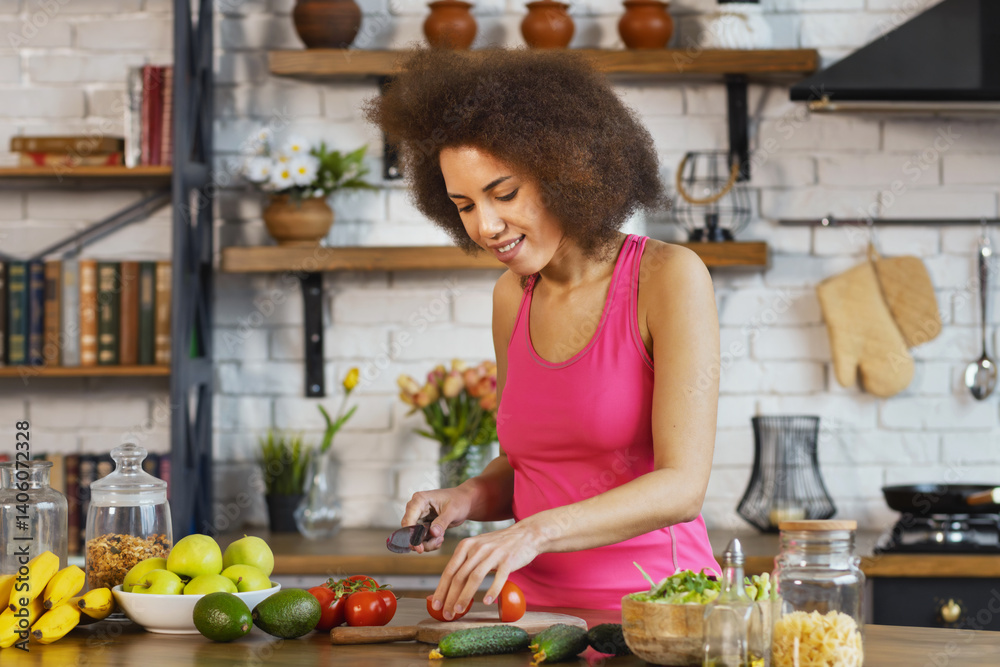Happy woman in top preparing healthy vegetable salad at home kitchen smiling and enjoying fresh organic ingredients for clean eating lifestyle