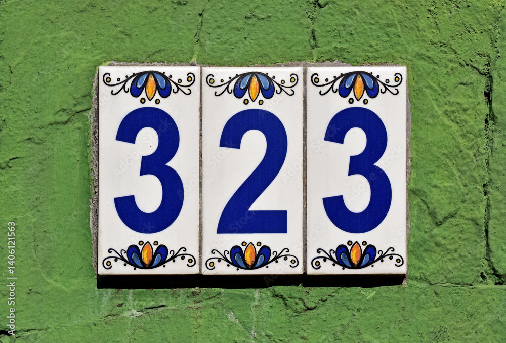 Street sign number 323 on a green wall, Rio de Janeiro, Brazil