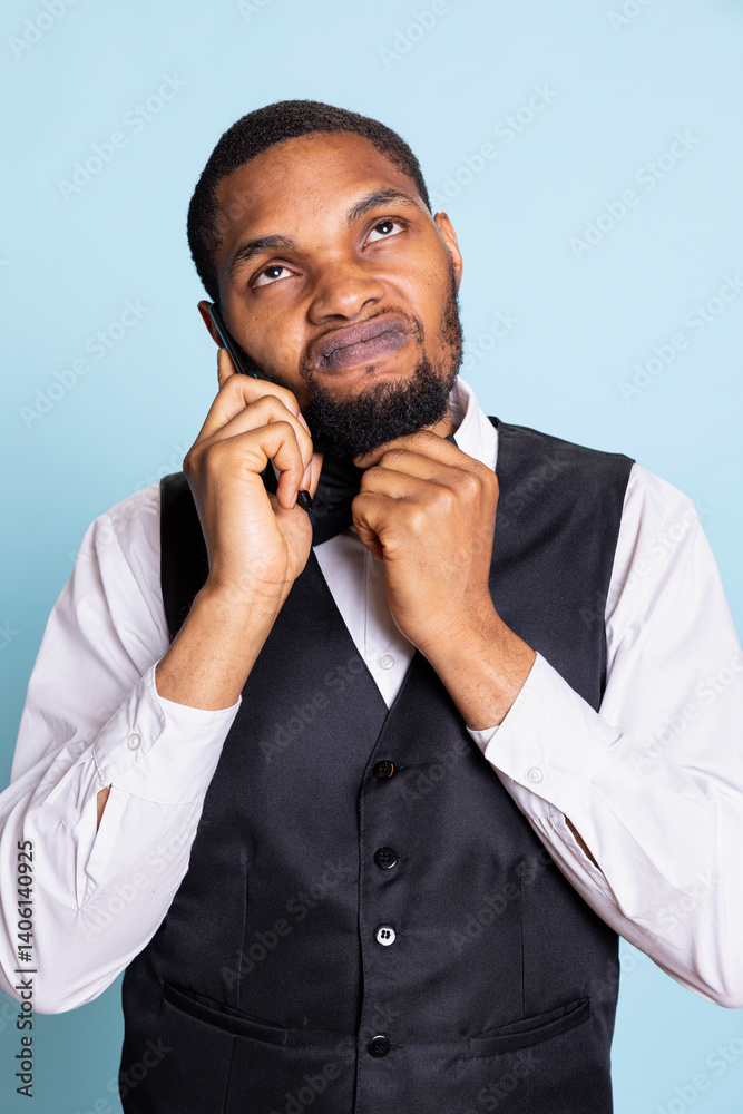 Professional front desk personnel chatting on phone call with guests, providing his concierge services and making remote room bookings. Answering questions about prices and availability. Professional front desk personnel chatting on phone call with guests, providing his concierge services and making remote room bookings. Answering questions about prices and availability.