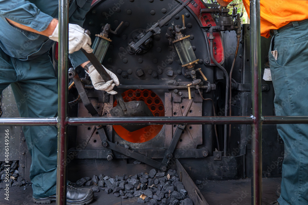Fototapeta premium stoking steam train engine firebox fire with coal, vintage history rail railway locomotive,