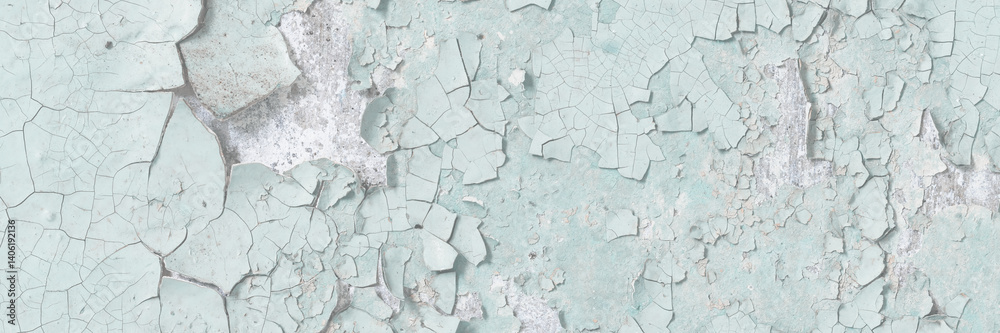Green peeling paint on the wall. Old concrete wall with cracked flaking paint. Weathered rough painted surface with patterns of cracks and peeling. High resolution texture for background and design.