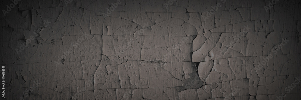 Dark wide panoramic background. Peeling paint on a concrete wall. Dark grunge texture of old cracked flaking paint. Weathered rough painted surface. Patterns of cracks. Darkness background for design.