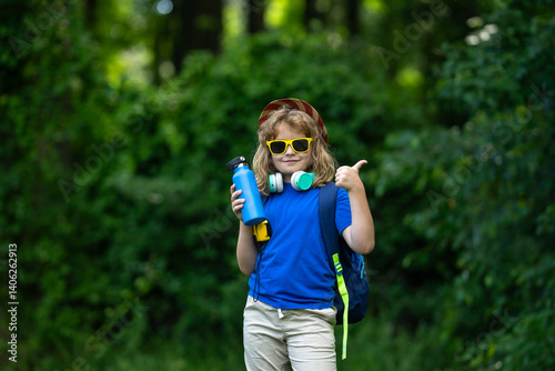 Obraz na płótnie Child enjoying a picnic in summer. Kid Fun on camping. Little tourist on nature. Child enjoying summer camp. Kid exploring nature outdoors. Happy child on a camping trip. Picnic with kids. w salonie