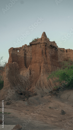 Path Through the Desert Vegetation in Colombia. A narrow trail cutting through arid vegetation with cacti and dry shrubs. Taken during sunset in a Colombian dry forest ecosystem, this photo is ideal f