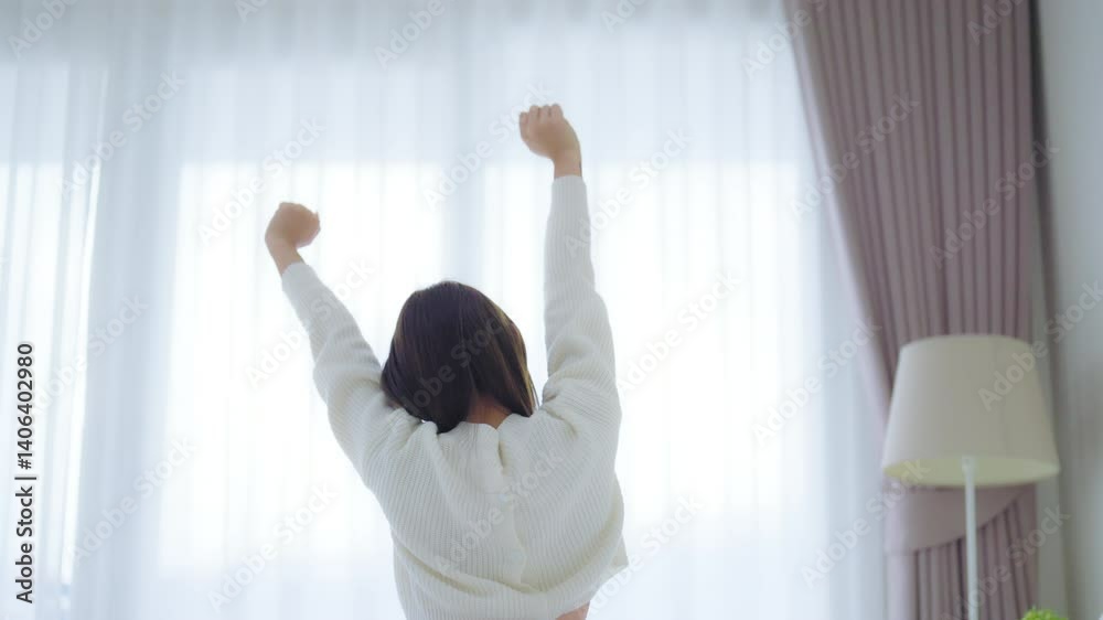 Young Asian Woman stretching in bed after waking up, back view, happy female and relaxed after good night sleep. Sweet dreams, good morning, new day, weekend, holiday, cozy and comfort Young Asian Woman stretching in bed after waking up, back view, happy female and relaxed after good night sleep. Sweet dreams, good morning, new day, weekend, holiday, cozy and comfort