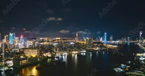 Wallpaper Mural Aerial view of the Macau peninsula skyline at night, featuring the illuminated Macau Tower, casinos, and city lights reflecting on river showcasing the vibrant nightlife and entertainment hub of this. Torontodigital.ca