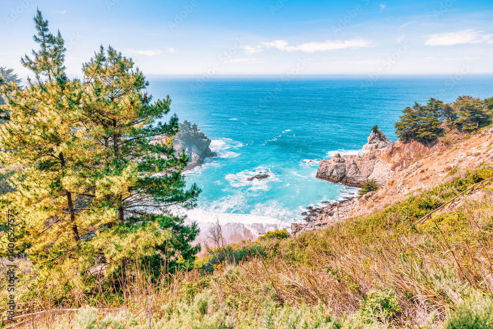 Fototapeta premium Stunning coastal landscape along California's Highway 1, featuring rugged rocky formations, and the vast blue ocean. A breathtaking natural scene showcasing the raw beauty of the Pacific coastline
