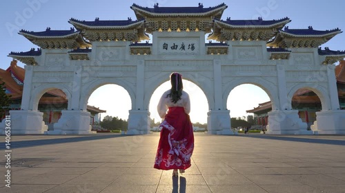 4k Slow motion video, Chiang Kai Shek Memorial Arch with morning sunlight and Asian women in Taipei, Taiwan.