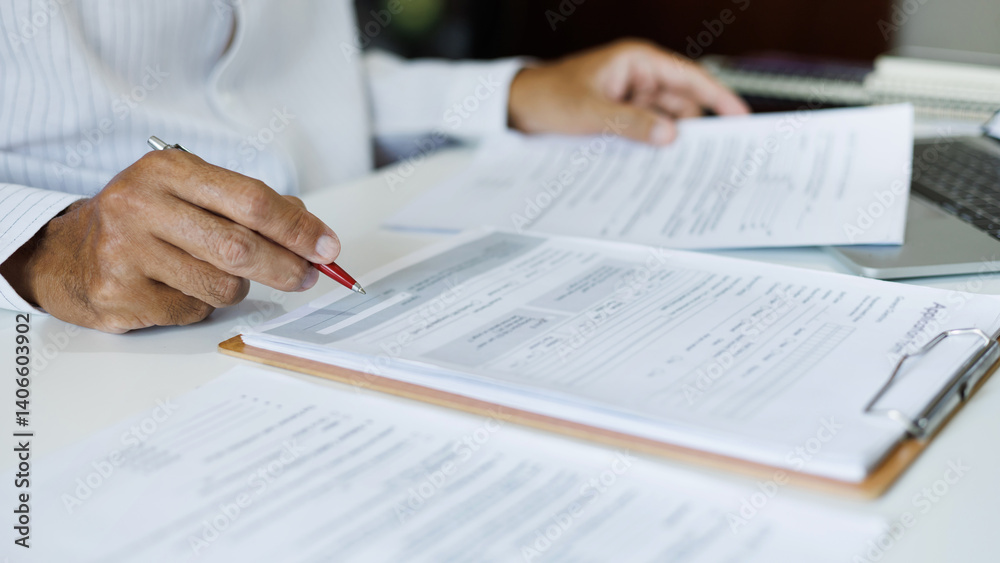 asian businessman reviewing document at office. legal expert, professional lawyer working with laptop reading and checking financial documents and business contract before sign, close up shot asian businessman reviewing document at office. legal expert, professional lawyer working with laptop reading and checking financial documents and business contract before sign, close up shot