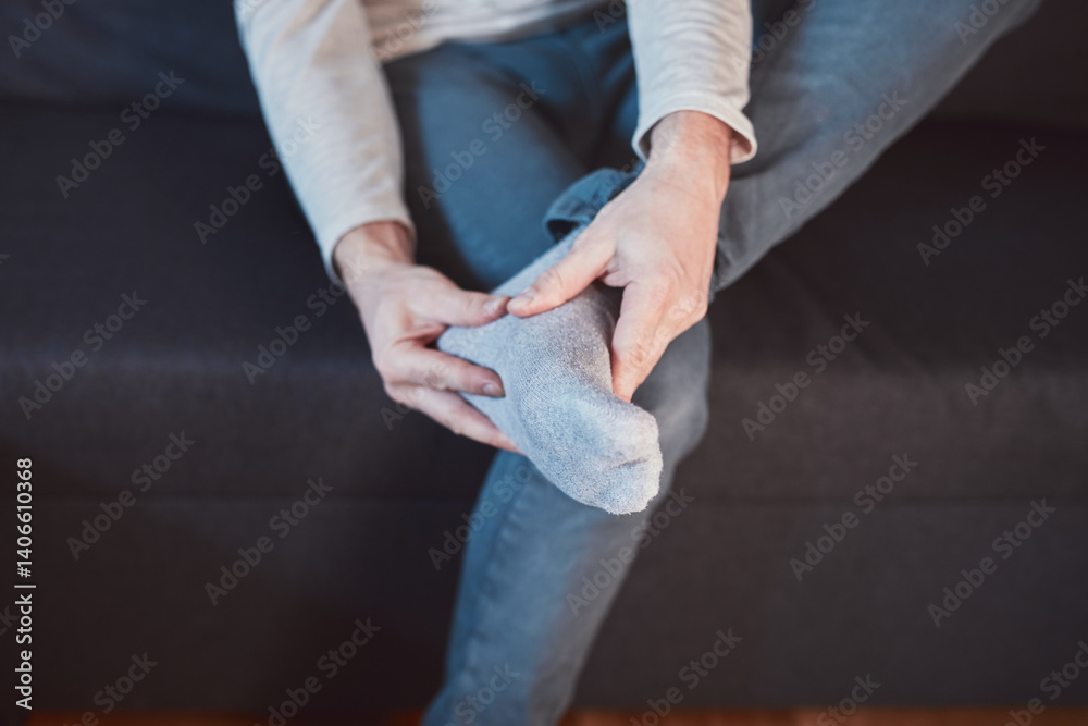 Man with ankle and foot pain at home.