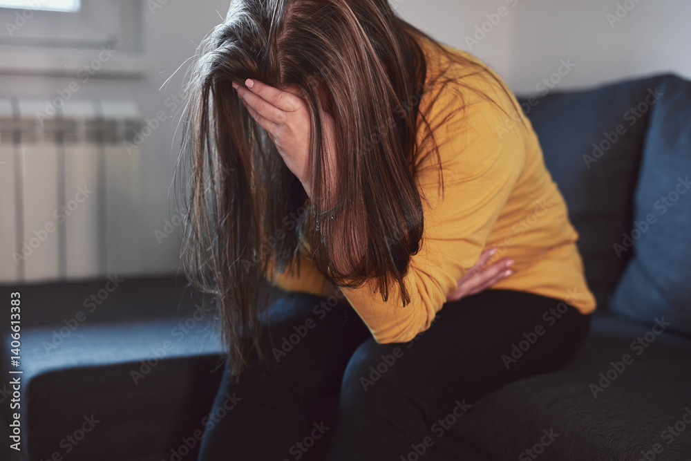 Woman with strong stomach ache, menstrual and digestive issues at home.