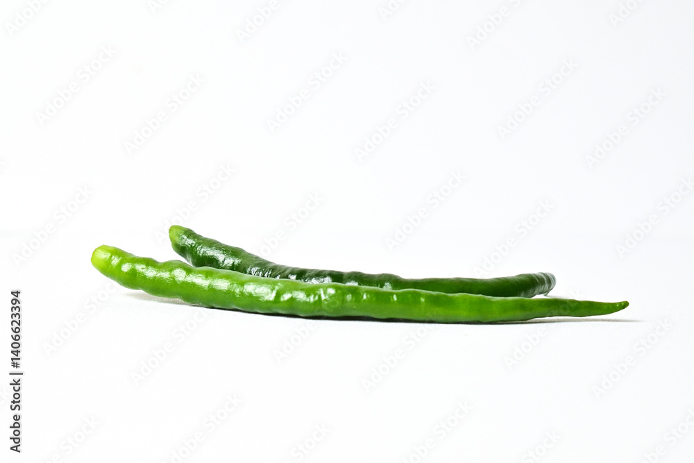 Close up view of two (2) fresh green chili peppers isolated on white background. Clipping path. Side view. Close up view of two (2) fresh green chili peppers isolated on white background. Clipping path. Side view.