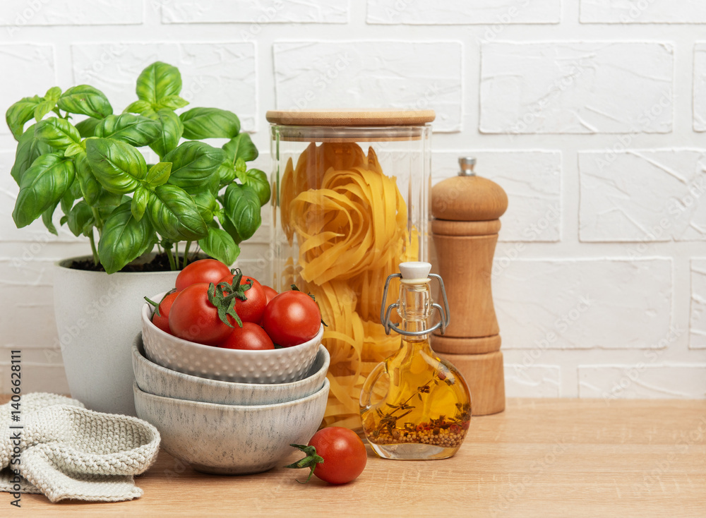 Cherry tomatoes, basil, pasta and olive oil creating an italian culinary scene