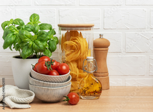 Obraz na płótnie Cherry tomatoes, basil, pasta and olive oil creating an italian culinary scene w salonie