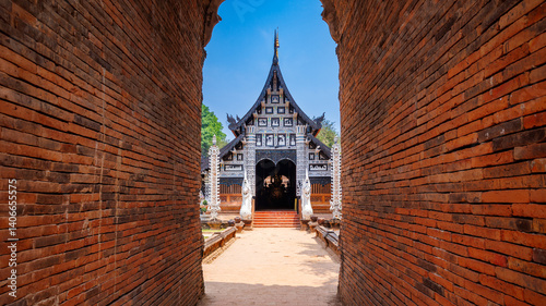 Wat Lok Moli  temple featuring a traditional wooden viharn with naga statues and an ancient brick chedi under clear blue sky, Chiang mai 
