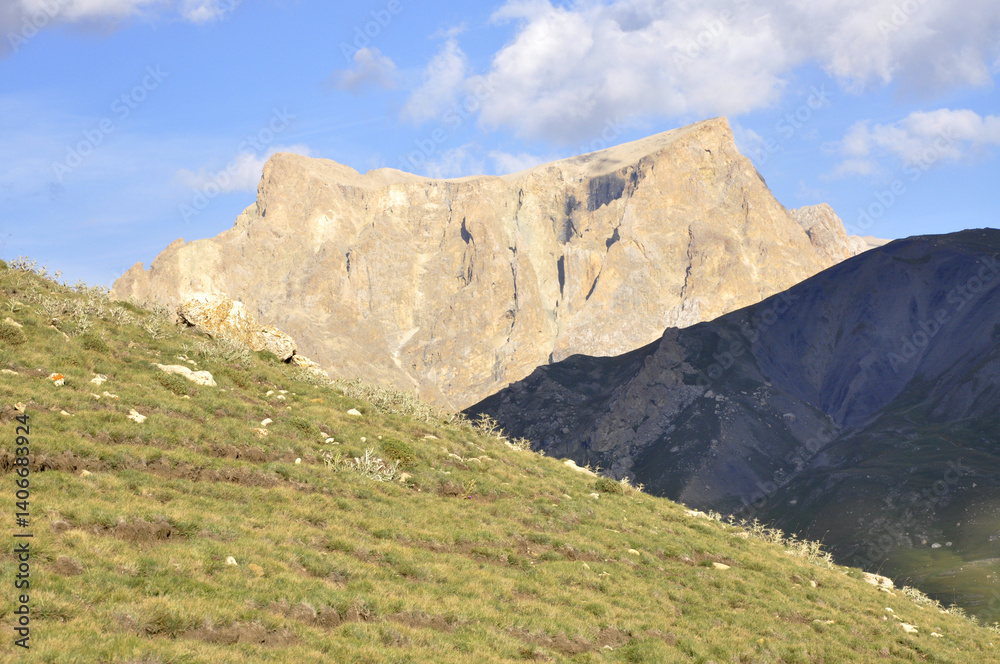 Fototapeta premium A perfect view of the harsh rocks and green plains from the peak of Shahdag in the Caucasus Mountains