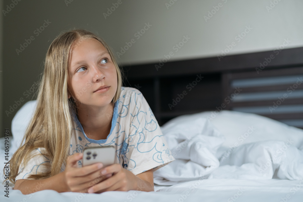 girl lying in bed with phone, communicating via internet girl lying in bed with phone, communicating via internet