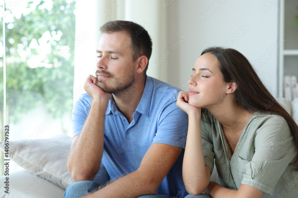 Couple at home relaxing with eyes closed at home Couple at home relaxing with eyes closed at home