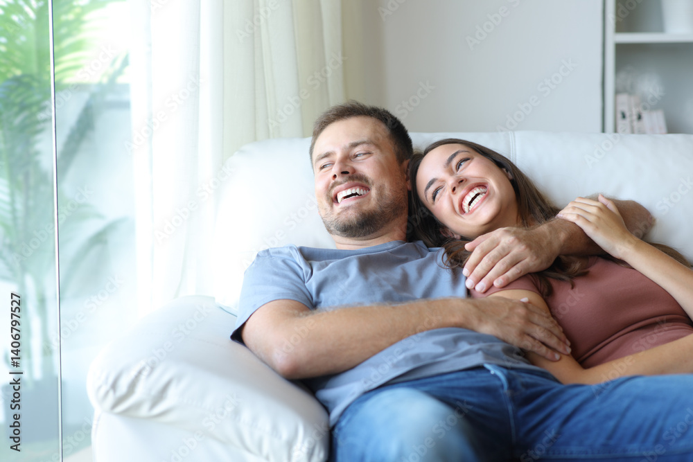Funny couple at home laughing looking through a window Funny couple at home laughing looking through a window