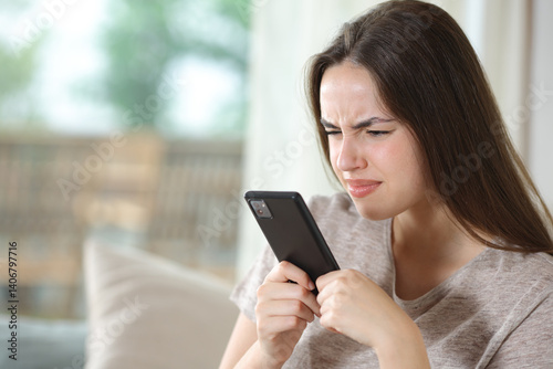 Woman with vision poroblems using phone forcing sight