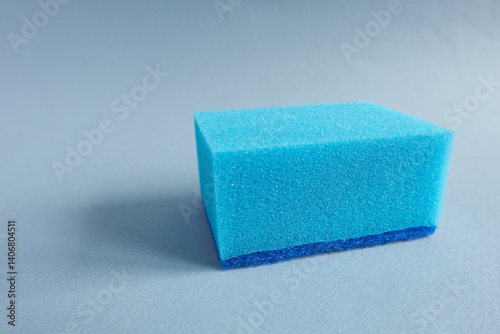 Blue sponges on blue background. Cleaning service concept.