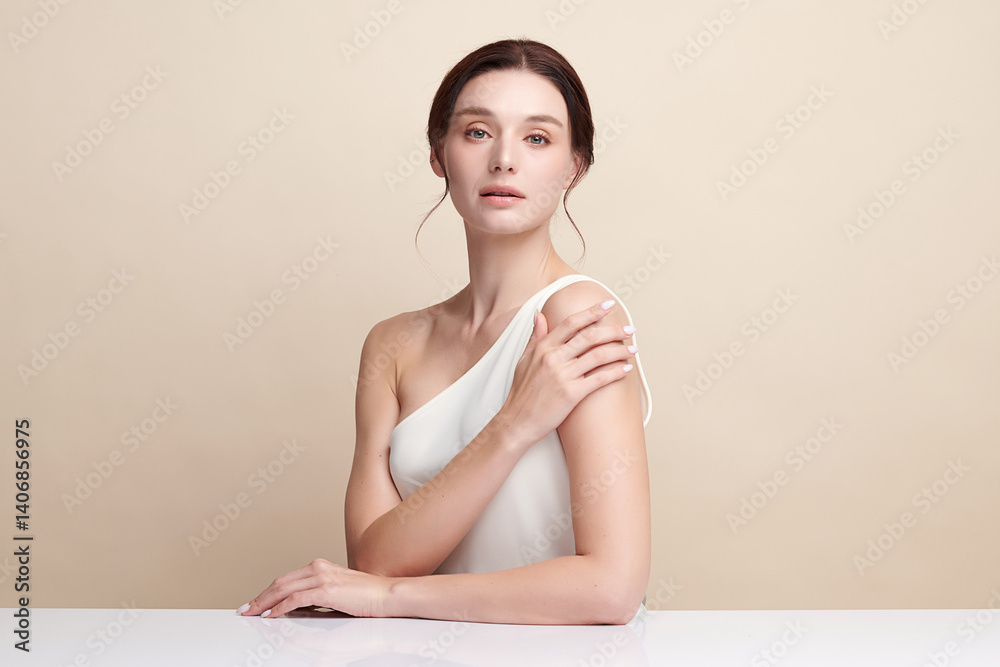 A beautiful young woman with clean, fresh skin against a beige background. Skincare, facial treatment, cosmetology, beauty, and spa. An elegant portrait of an woman. A beautiful young woman with clean, fresh skin against a beige background. Skincare, facial treatment, cosmetology, beauty, and spa. An elegant portrait of an woman.