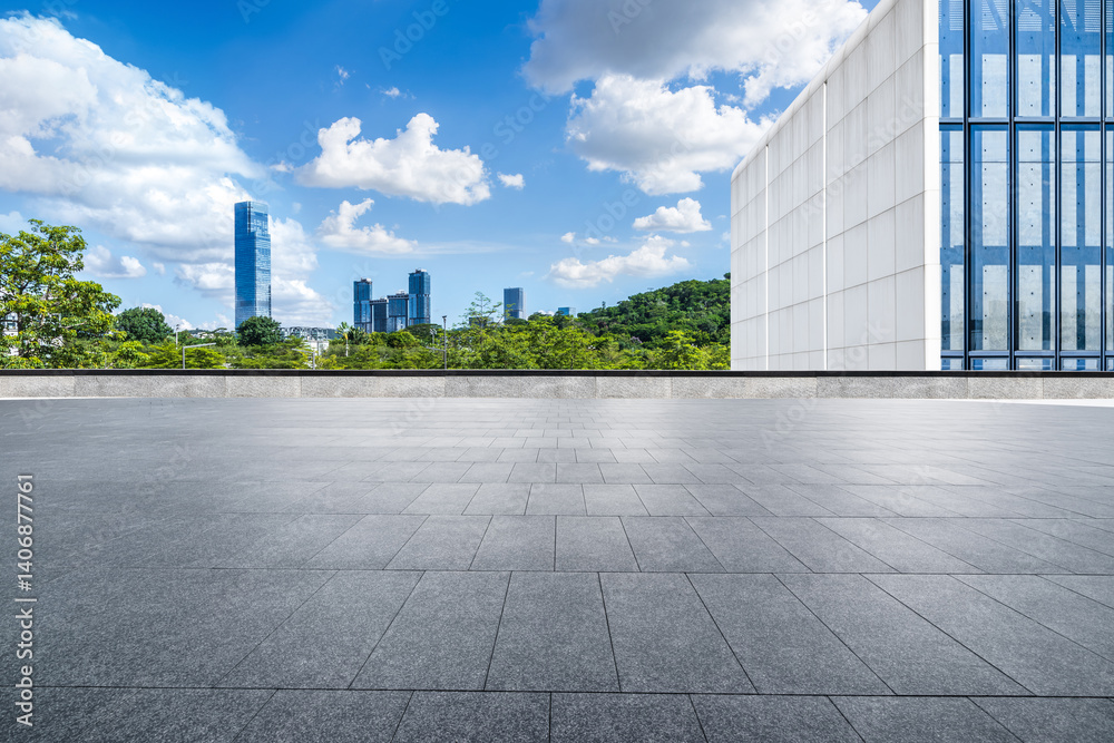 Fototapeta premium Empty square floor and modern buildings with cityscape under blue sky