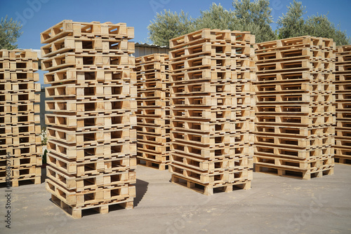 Obraz na płótnie Stacked Wooden Pallets Outdoors in a Storage Facility on a Sunny Day. w salonie