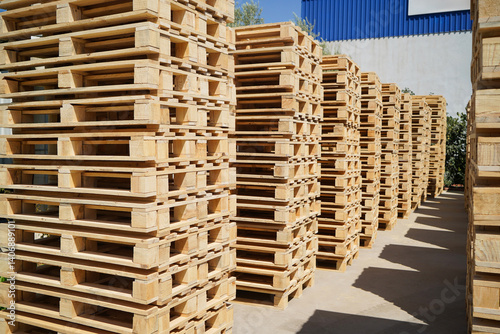 Obraz na płótnie Stacks of Wooden Pallets Vertical Arranged Outdoors in Industrial Factory Setting w salonie
