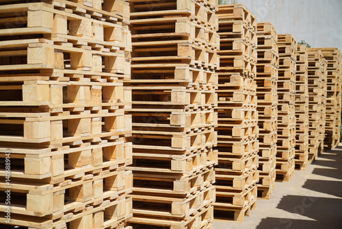 Obraz na płótnie Stacks of Wooden Pallets Vertical Arranged Outdoors in Industrial Factory Setting w salonie