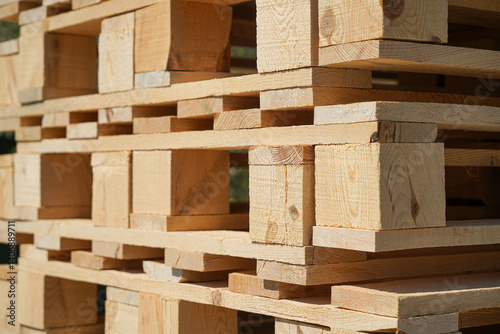 Obraz na płótnie Stacked Wooden Pallets Outdoors in Sunshine for Industrial or Storage Use w salonie