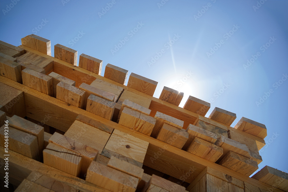 Stack Of Wooden Palette Blocks Against Bright Blue Sky With Sunlight