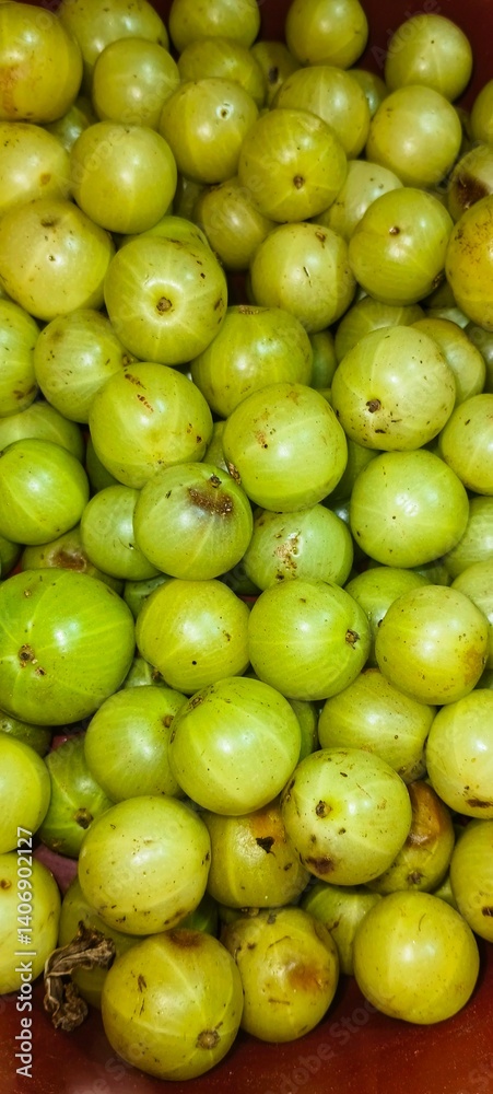 a close-up view of a bunch of Indian gooseberries, also known as Amla a close-up view of a bunch of Indian gooseberries, also known as Amla