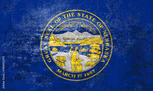 Nebraska State Flag. Dirty Nebraska state flag on the wall.