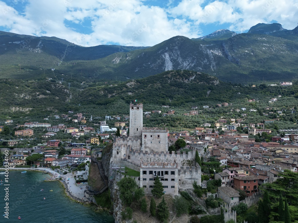 Naklejka premium Drone Flight Over Malcesine Village and Historic Castle on Lake Garda