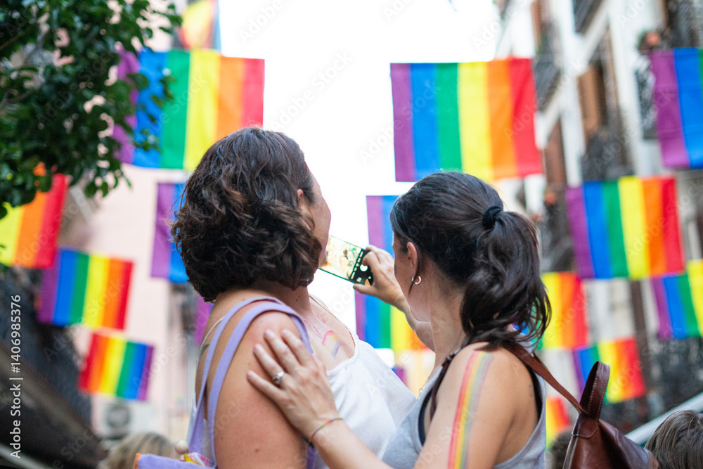 Obraz premium Women taking photos at gay pride parade celebrating lgbtq+ rights
