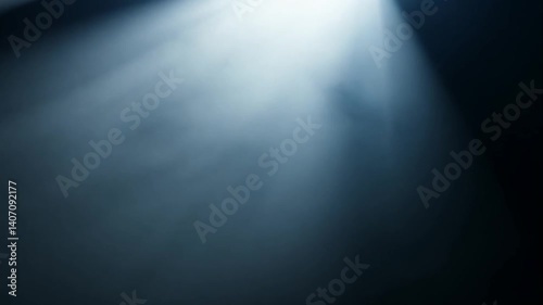 Dramatic beams of light breaking through darkness, creating an ethereal atmosphere with swirling dust particles and a mysterious ambiance suitable for artistic backgrounds or projects.
