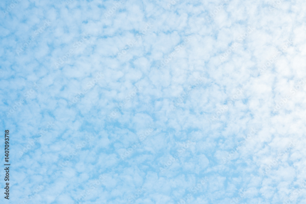 Bright blue sky filled with cotton-like clouds on a sunny day Bright blue sky filled with cotton-like clouds on a sunny day