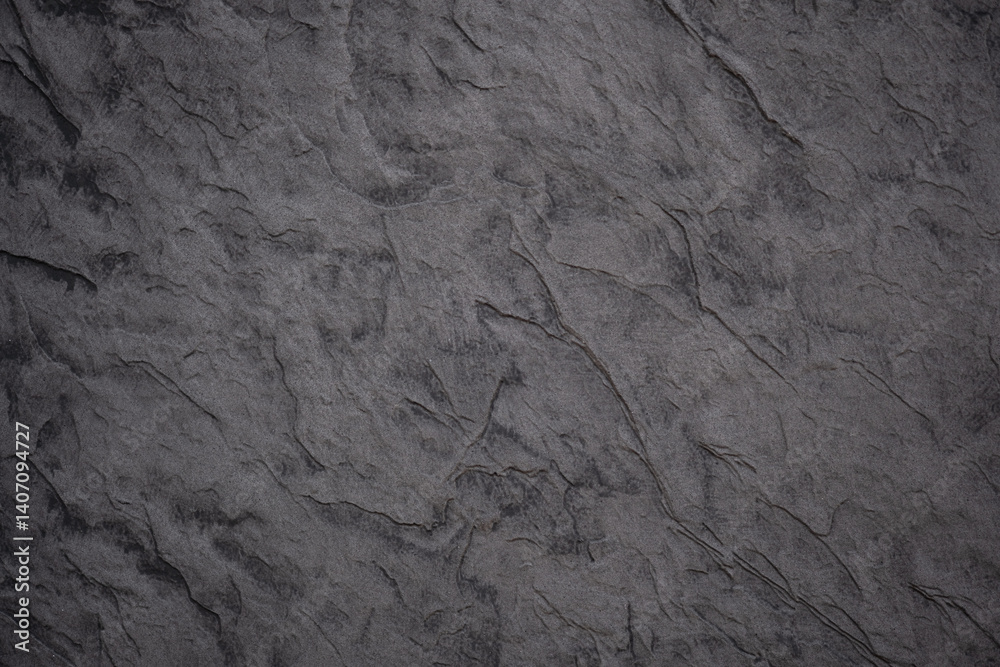 Fototapeta premium Grey textured surface showcasing intricate rock patterns in natural lighting
