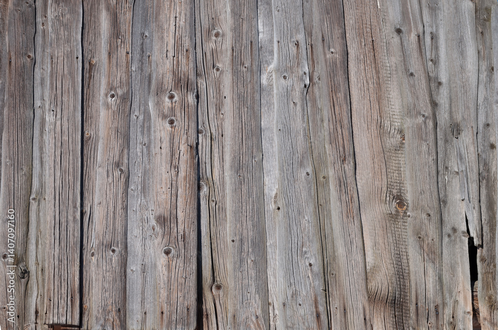 Texture of old weathered wooden fence made of slabs